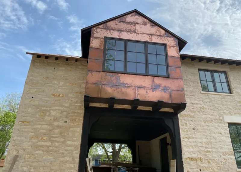 Copper metal panel facade on a stone building for Skylight Installation in Belle Chasse