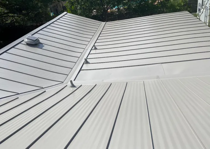 Solar attic fan installed on a metal roof for Roof Ventilation in Belle Chasse